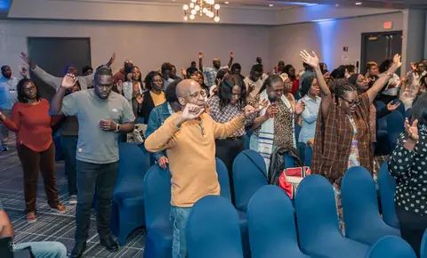 The whole room in worship