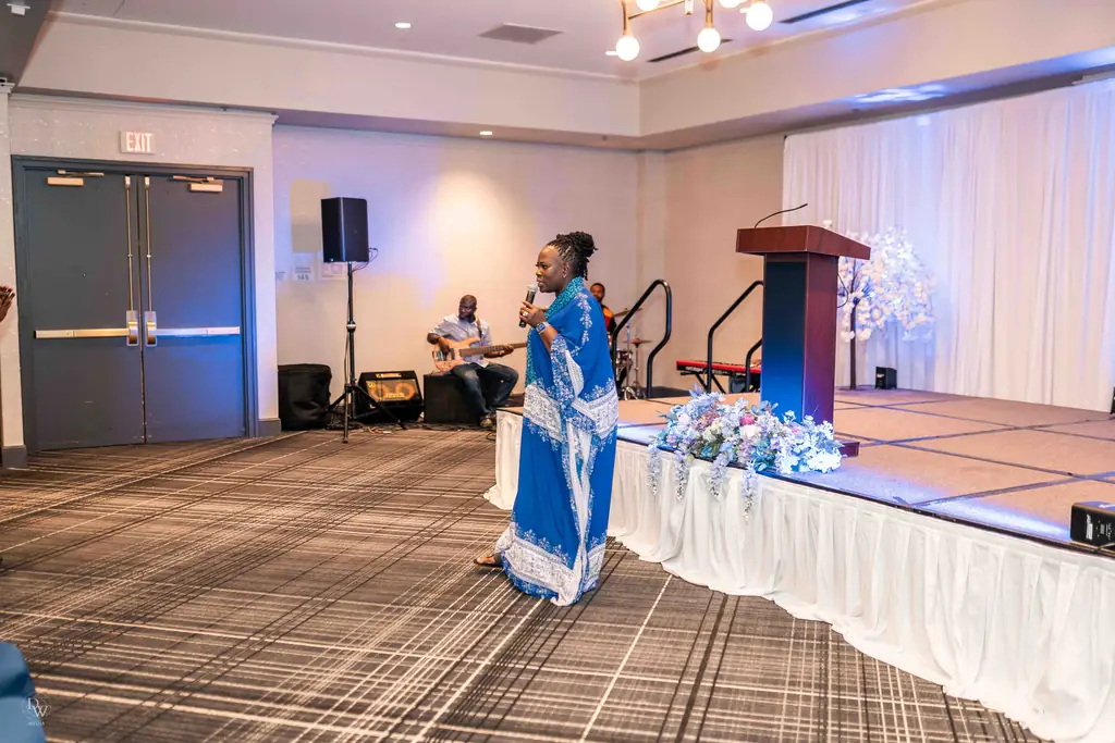 The room set for worship, with a singer at the front