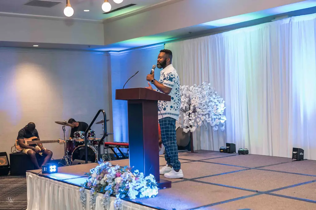 A preacher speaking from the stage