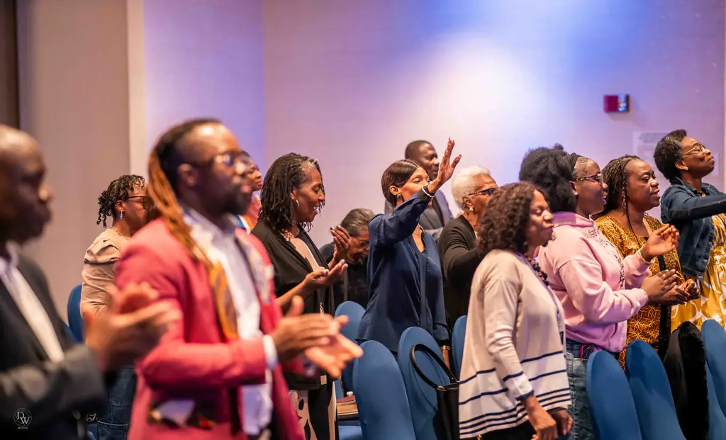 The congregation clapping and singing together