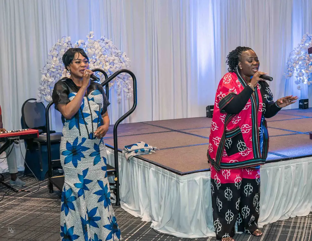 Two women singing on stage