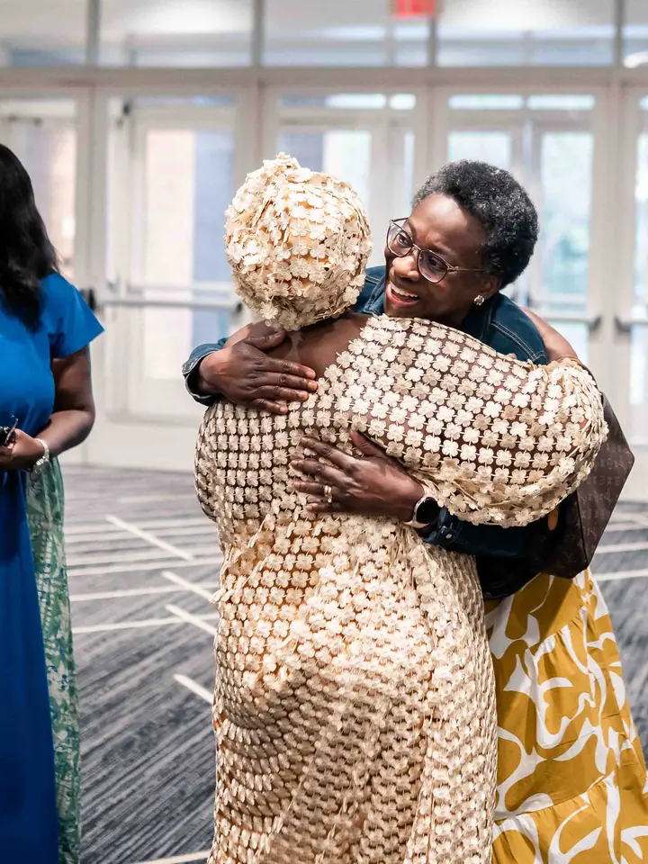 Two members greeting each other with a hug